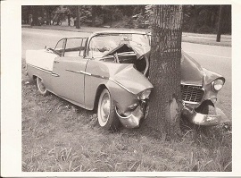 A vintage 1950's postcard of a wrecked Chevrolet